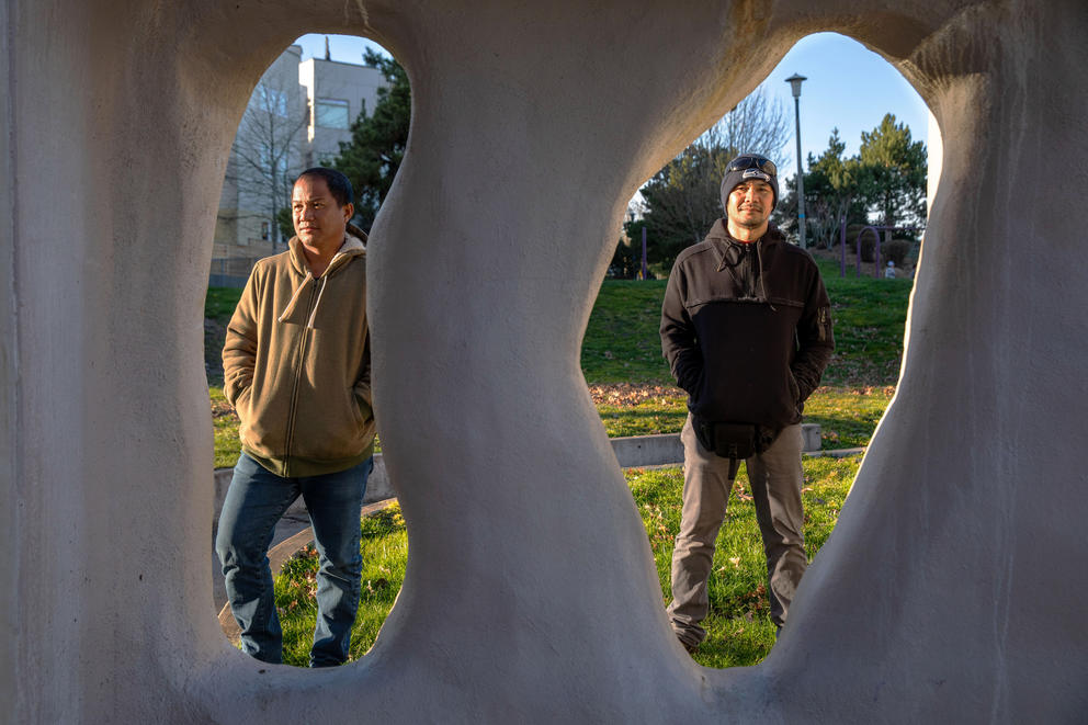 Mickel and Cabrela pose for a photo, framed by public art in a Seattle park