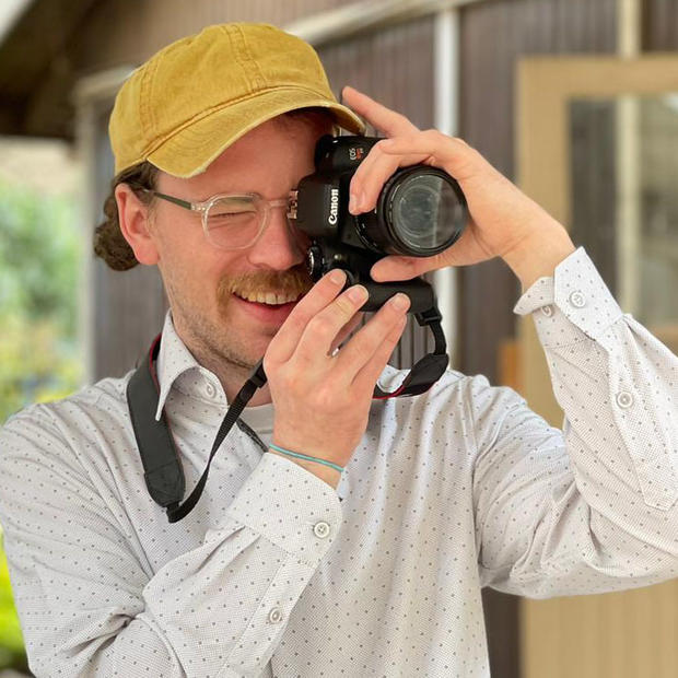 Nick Gibson holding a camera