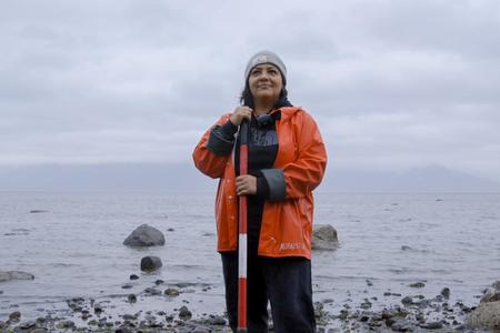 Scientist Rosa Hunter stands by the shore