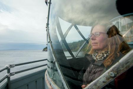 woman looking out of window in lighthouse