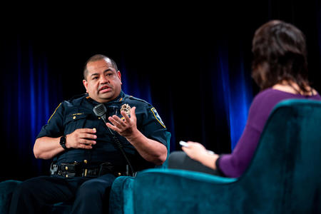 Seattle Chief of Police Adrian Diaz on stage with host Mónica Guzmán