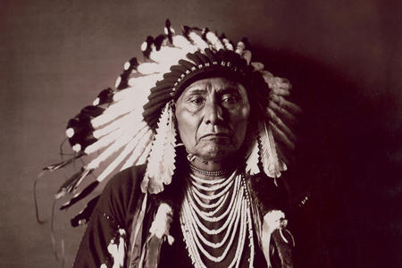 Archival image of man in Native headdress
