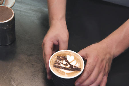 A coffee drink with a image of a tennis shoe in the foam
