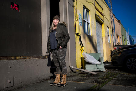 Jodi Opitz, owner of Seattle Rehearsal, stands for a portrait in front of a “no parking” sign she keeps up on her building to make sure her business is accessible to herself and her customers 24/7 on Occidental Avenue South in Seattle's SODO neighborhood.