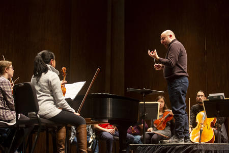 A conductor directs an orchestra