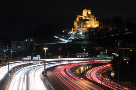 a nighttime photograph of I-5, car lights streaming by