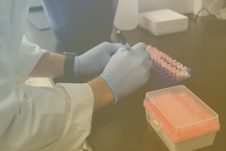 Blue medical gloves holding sharpie marker doing lab work