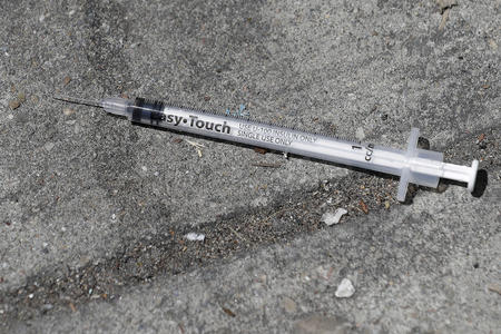 syringe on a sidewalk