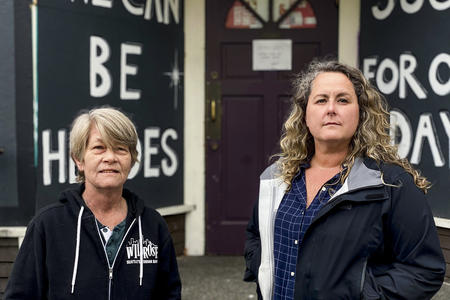 Wildrose owners Shelley Brothers and Martha Manning in front of their closed Capitol Hill bar