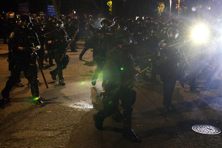 Seattle Police Department officers advance on demonstrators