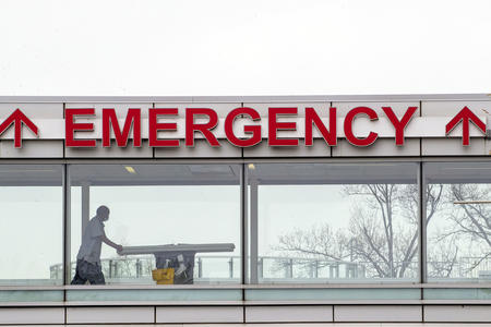 A building sign reads "EMERGENCY"