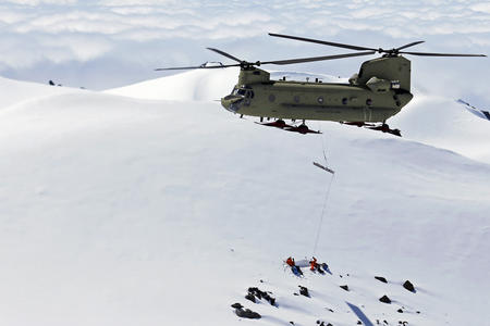 Rescue helicopter over snowy mountain