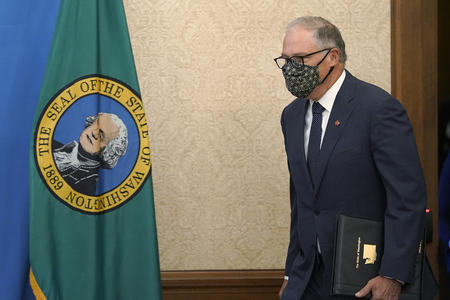 Inslee enters room with mask on