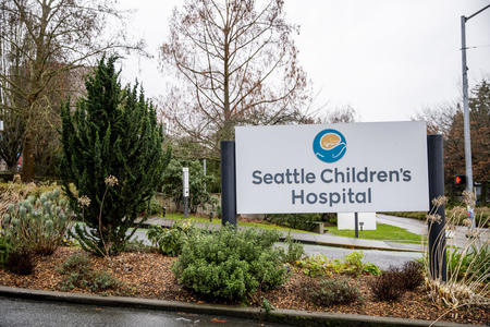 A Seattle Children's Hospital sign sits at an entryway to the hospital. 