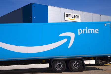 Amazon truck with logo in front of buiding