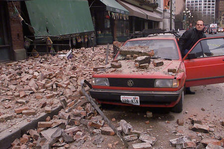 Paul Riek checks to see if his car starts after parts of the top half of a nearby building fell on it, during an earthquake in downtown Seattle, Wednesday, Feb. 28, 2001.	Credit: Stevan Morgain/AP