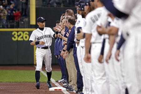 Seattle Mariners' Ichiro Suzuki, left, greets teammates as he is introduced before the team's opening day baseball game against the Cleveland Indians Thursday, March 29, 2018, in Seattle. (AP Photo/Elaine Thompson)