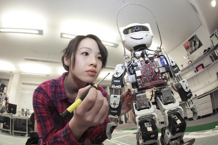 female student building robot