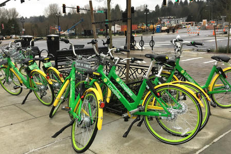 Seven LimeBike bicycles are parked in a cluster near the corner of Bothell Way and Main Street in downtown Bothell on Thursday, Feb. 1, 2018. LimeBike said it initiated a "gradual roll-out" in Bothell in mid-January, the first time private bike-share has expanded into Seattle's suburbs.	Credit: Kristen M. Clark/Crosscut