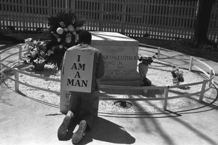 A man wearing a sign that reads I AM A MAN