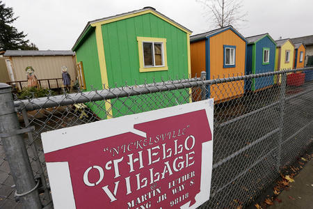 a row of colorful tiny home homeless shelters in seattle