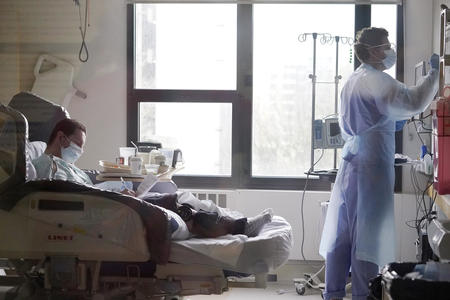 A doctor and patient in a hospital room