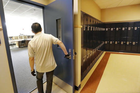 School janitor opens a door inside Bothell High School