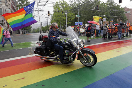 Woman on motorcycle at Pride parade