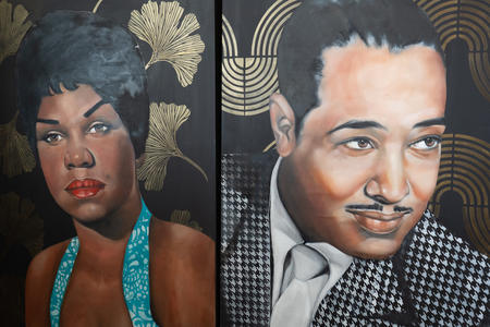 two oil paintings side by side, a black woman and man from the 1940s