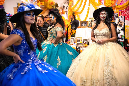 Women in elaborate dresses and face paint