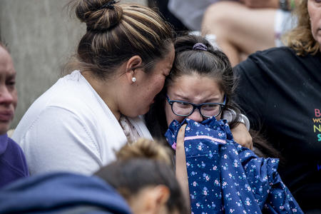 Jose Robles’ wife and daughter, Natalie, 9, embrace as they learn that Robles had been detained by ICE in Tukwila on July 17, 2019.