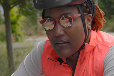 Alison wearing sunglasses and a bike helmet