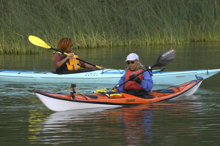 Alison Mariella Désir and Denice Rochelle paddling kayaks