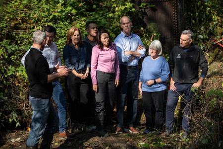 Federal Democratic officials observe a culvert in King County