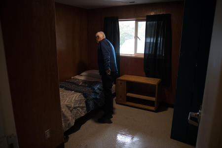 Secret Harbor President and CEO Brian Carroll tidies a bedroom inside of the organization's homes in Burlington, Washington