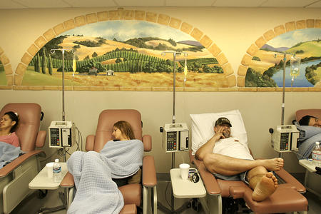 Patients sit in medical reclining chairs to receive medication