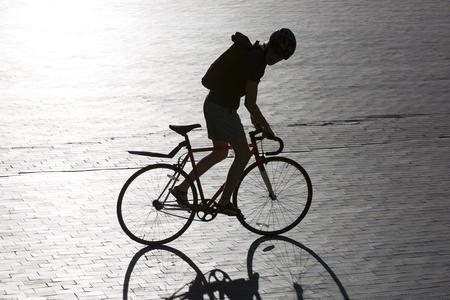 a bicyclist rides on university of washington campus
