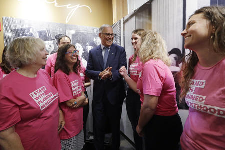 Gov. Jay Inslee talks with supporters of Planned Parenthood