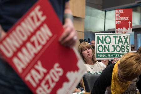 Woman hold no tax on jobs sign