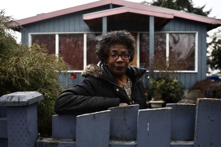 woman leans against fence in seattle