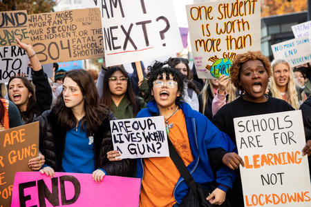 Students in Seattle hold signs in protest of gun violence at schools.