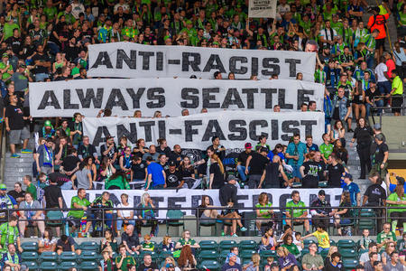 Sounders fans wave anti-racist and anti-fascist banners