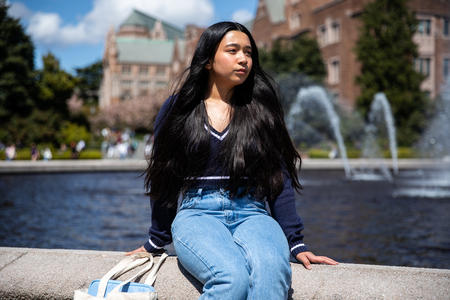 Kimberly Quiocho sits at UW's Drumheller Fountain