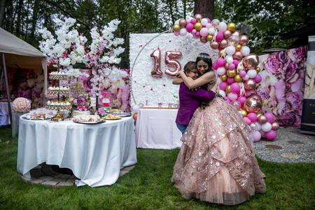 A mother and daughter hug during a quinceanera 