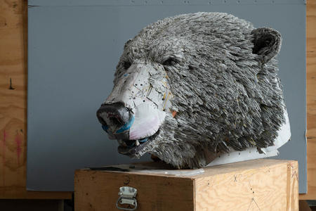 photo of a sculpture of a polar bear head, made from recycled cardboard