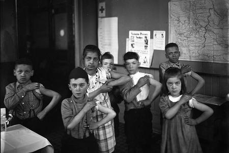 school children showing of their recent vaccinations