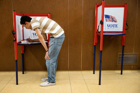 Man filling out a ballot