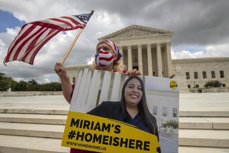 An activist stands in front of the Supreme Court Building