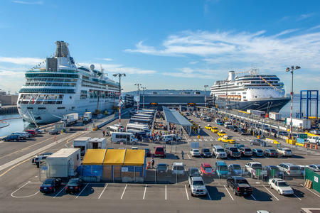 Cruise ships sit near a loading dock