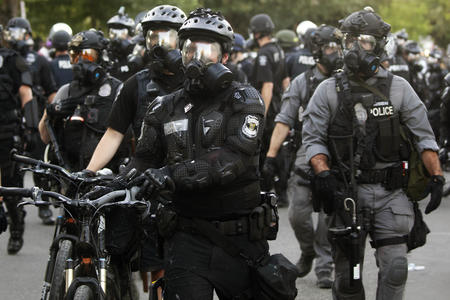 a crowd of police officers in riot gear